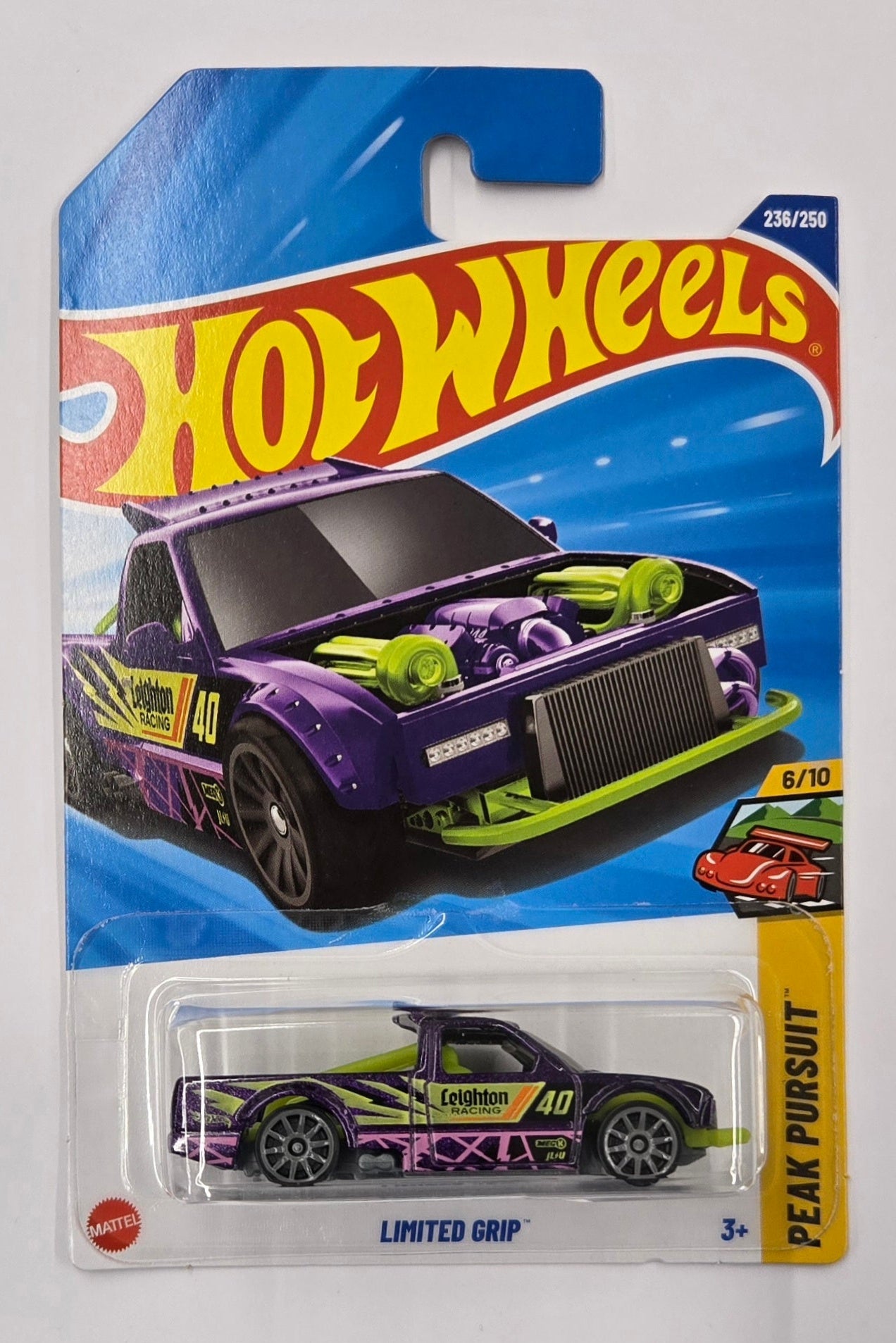 Hot Wheels toy car in packaging on a white sheet with a dark background