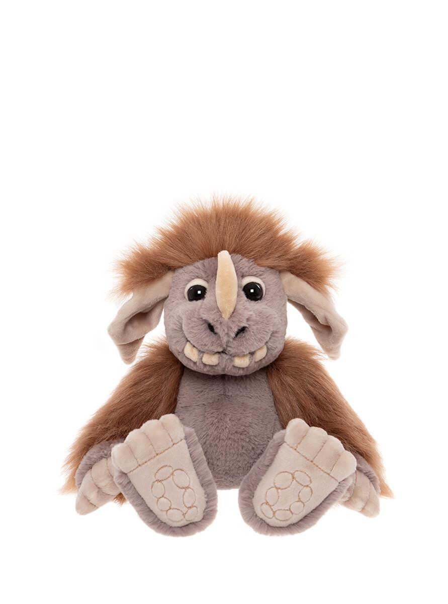 Plush toy resembling a creature with brown fur and gray body on a white background