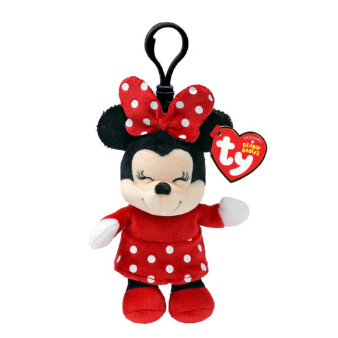 Plush keychain of a character in a red dress with white polka dots on a white background